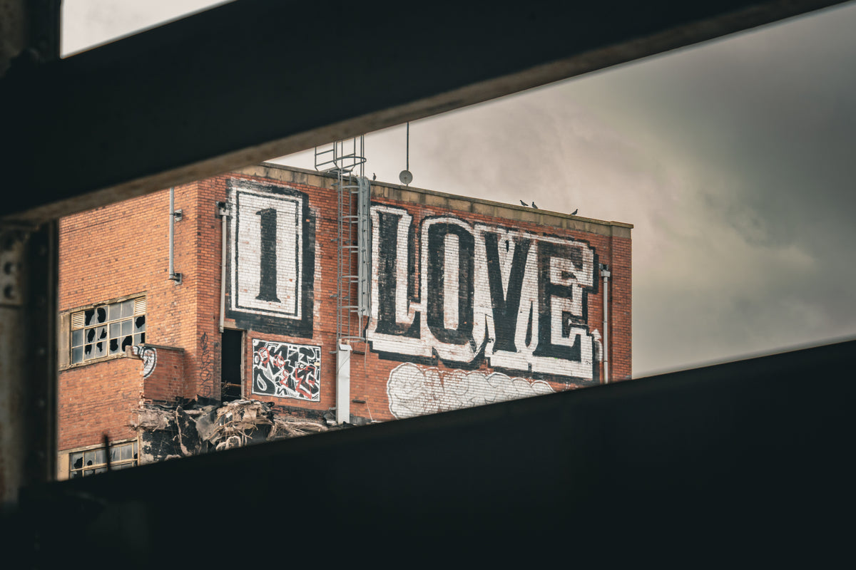 The 1 Love graffiti on the former Twyfords Etruria Works, Garner Street, Stoke-on-Trent, framed between concrete beams during demolition